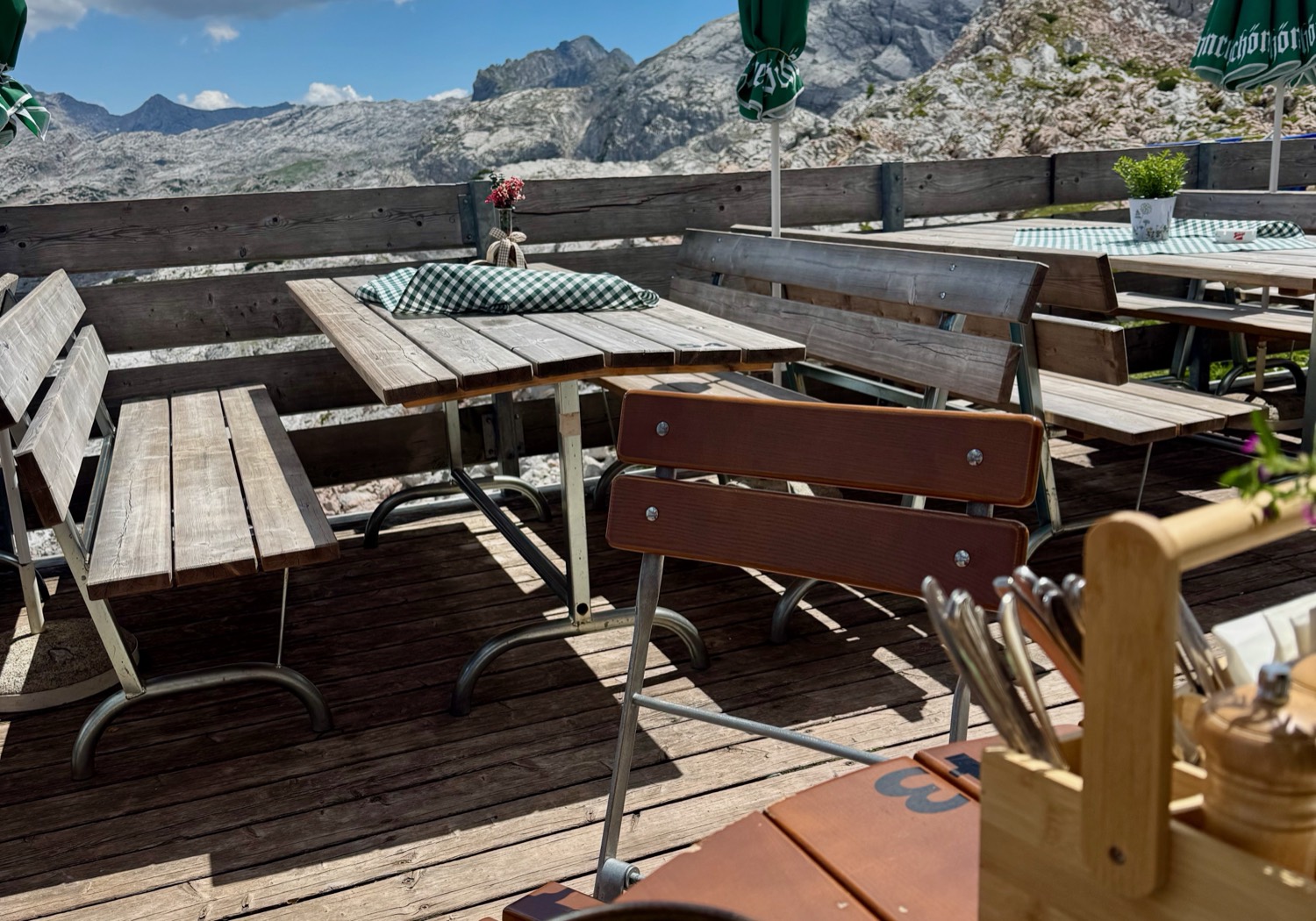 The terrace of a mountain hut looking out over the plateau and distant ranges